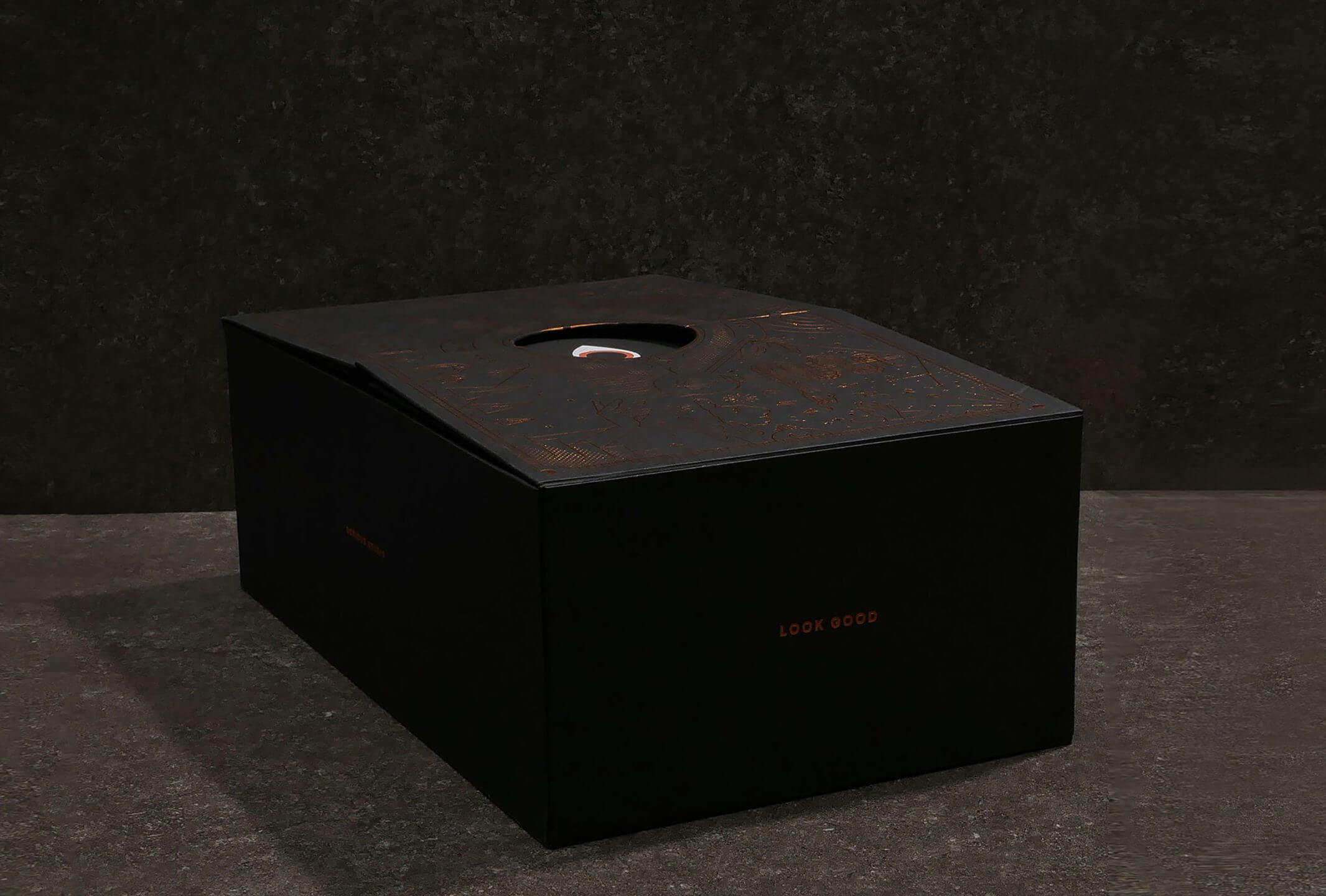 Christmas gift packaging box with intricate pattern in rose gold foil stamping