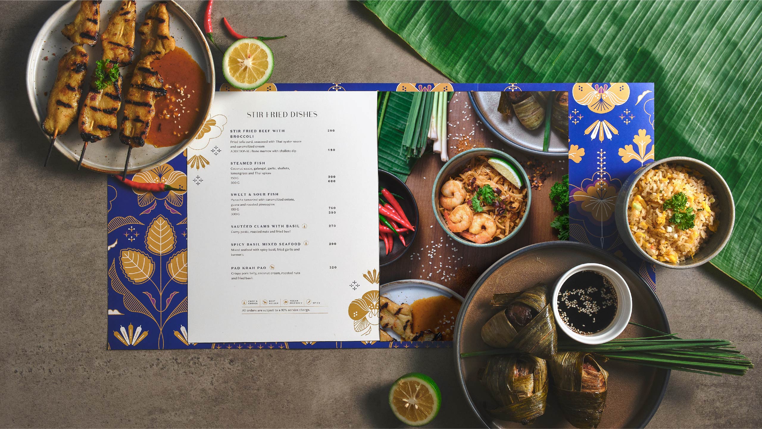 A flatlay of styled Thai food and a menu for modern Thai restaurant Muang Thai