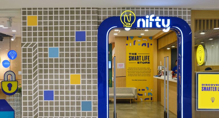 Store facade with a fun geometric mural for retail tech brand Nifty