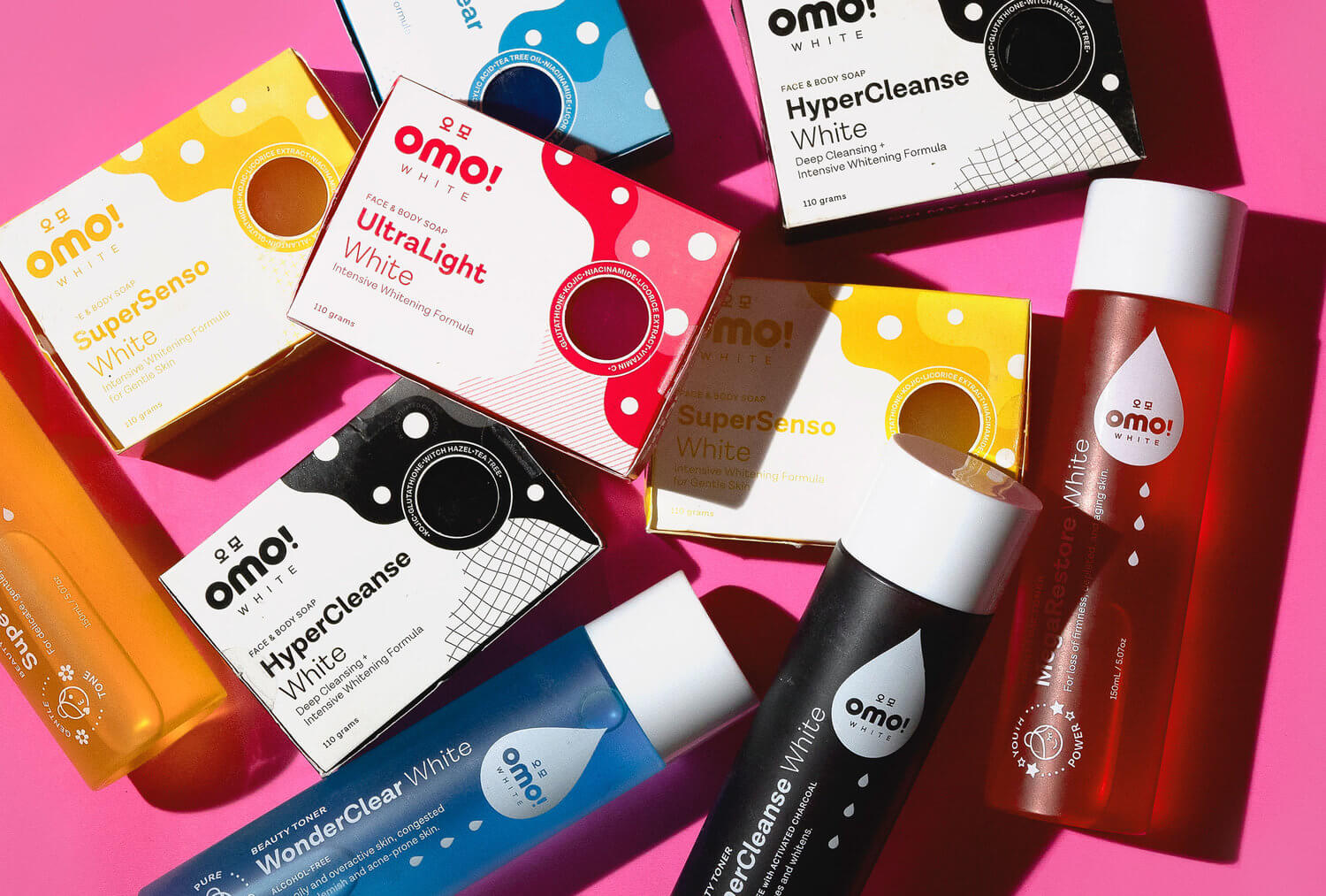 A flatlay of products and packaging designs for beauty and skincare brand Omo! White