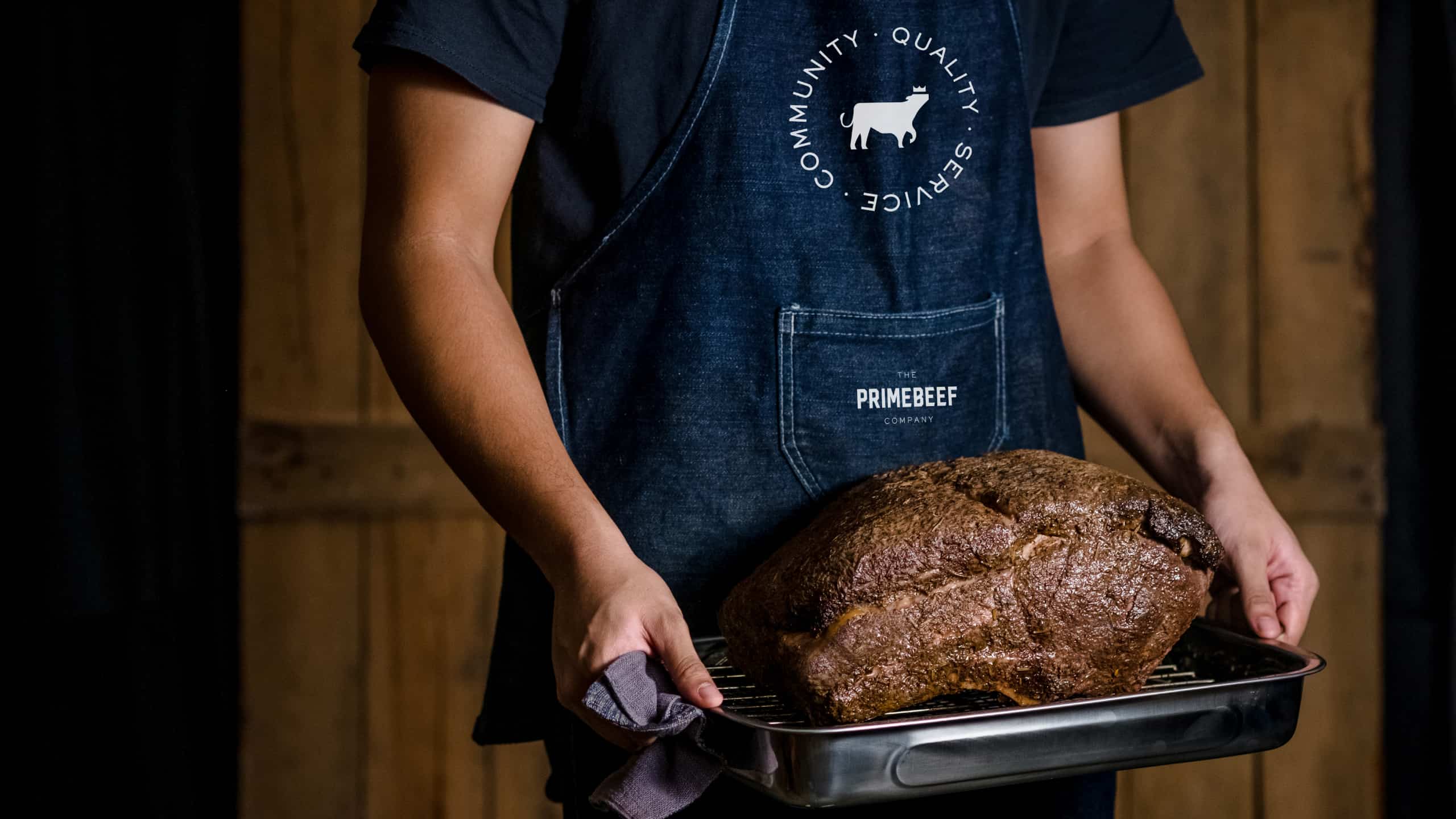 Delicious cut of meat carried by man in branded apron for Filipino meat brand Primebeef