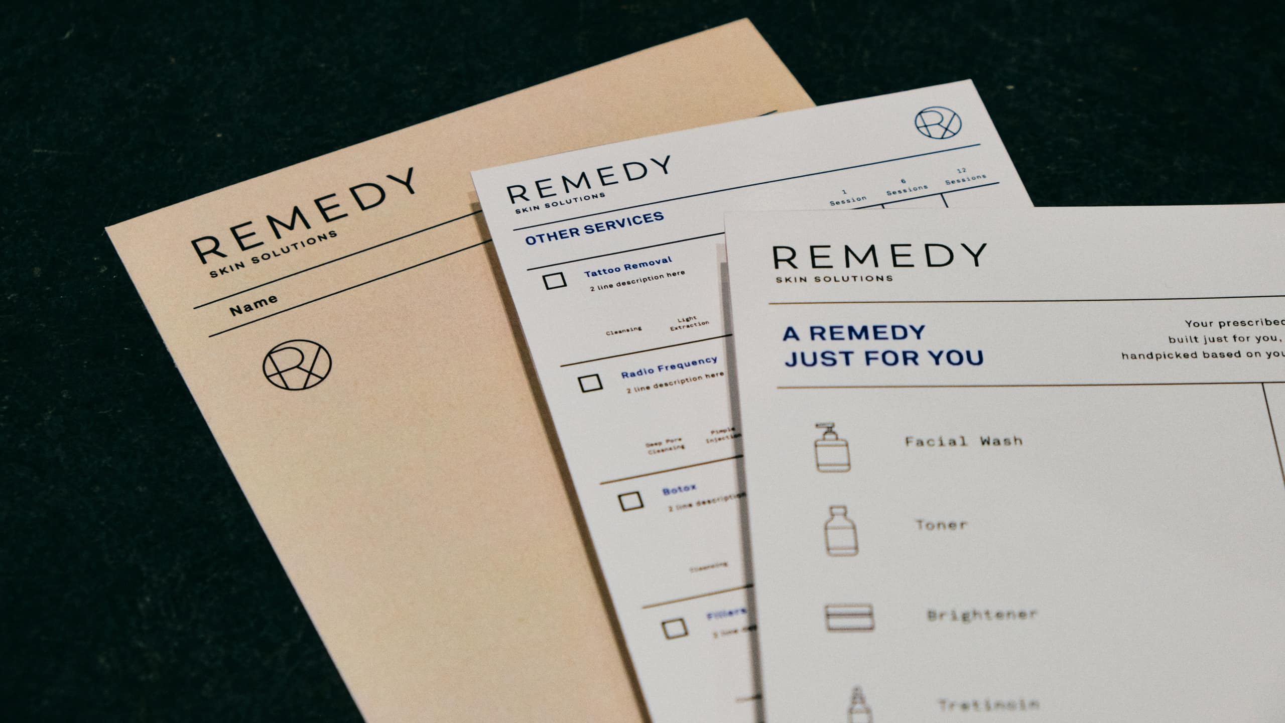Close up photo of branded collaterals for dermatology clinic and brand Remedy Skin Solutions