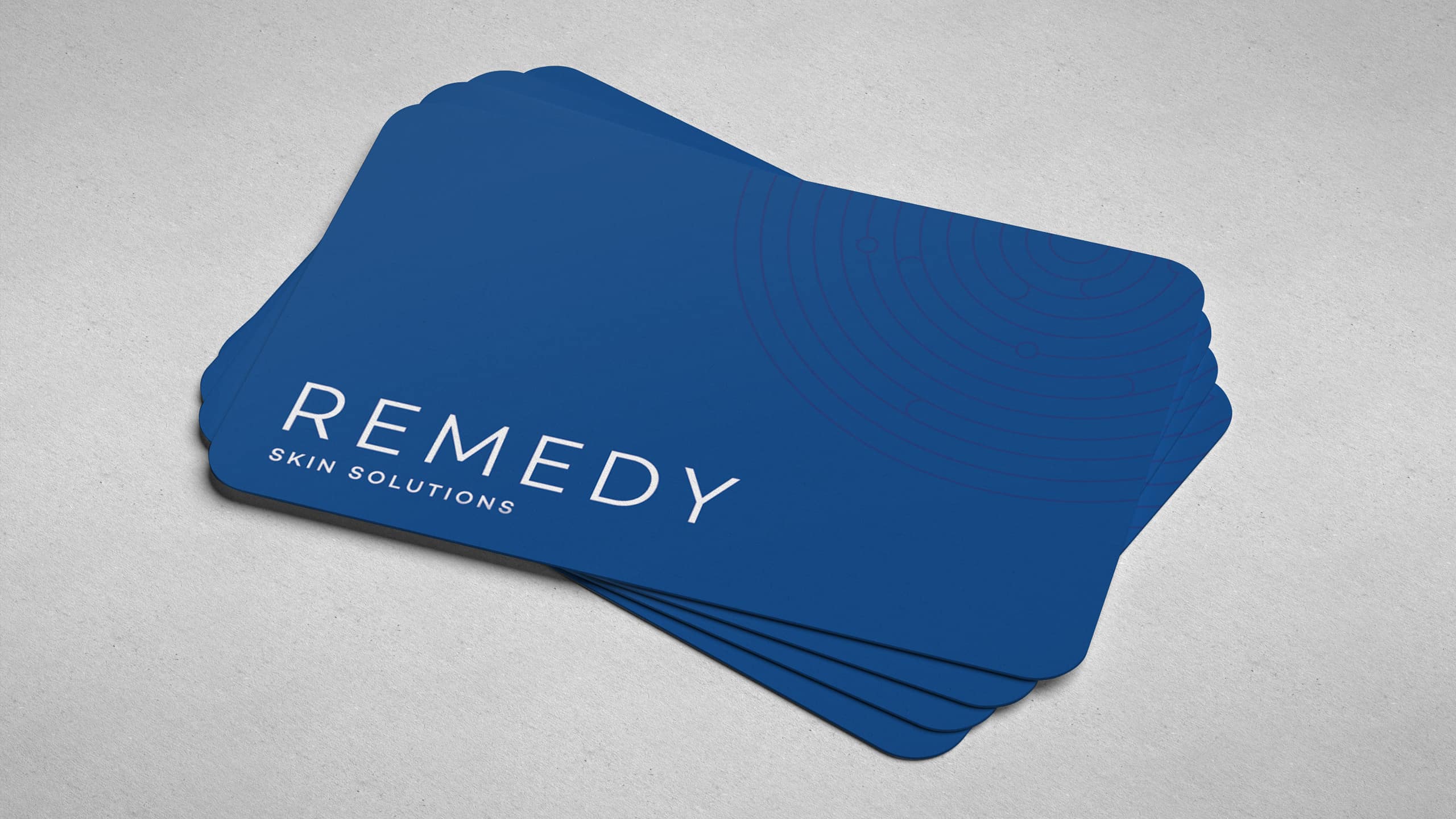Blue branded business card for dermatology clinic and brand Remedy Skin Solutions