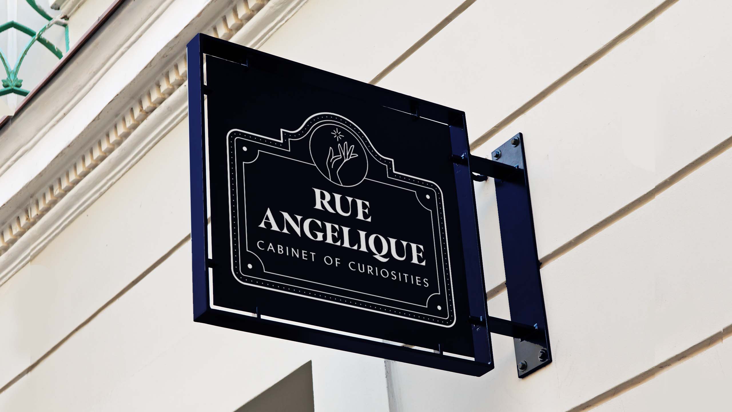 A mock up of a signage with the logo of antiques store Rue Angelique