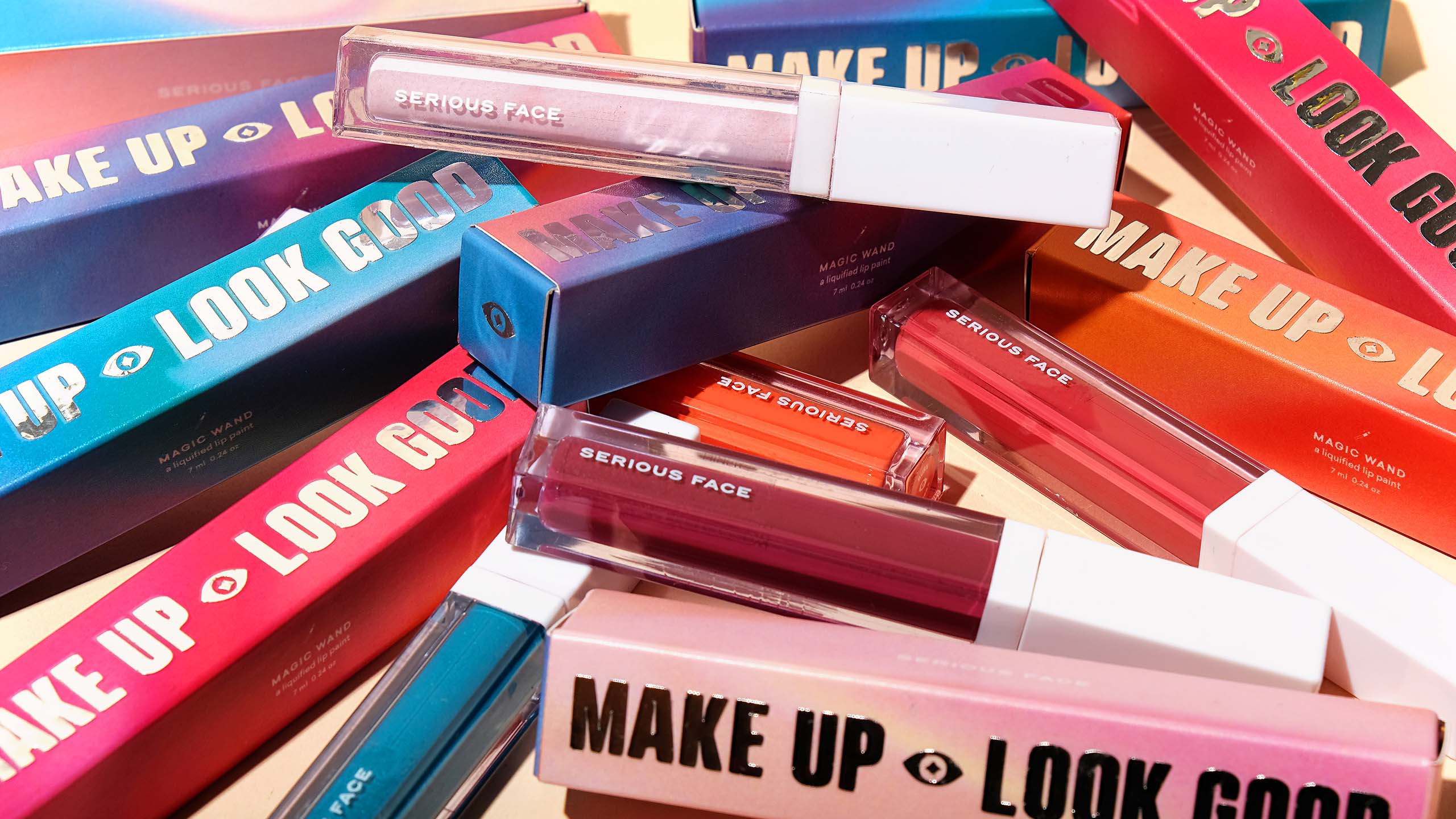 Tubes of Serious Face lipsticks or beauty sticks and their silver and gradient packaging
